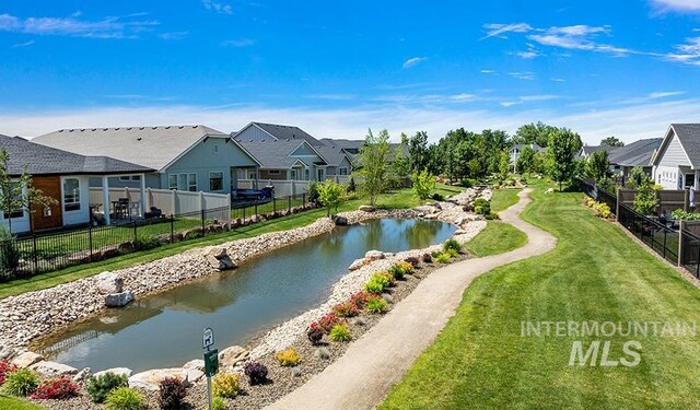 water view with a residential view and fence
