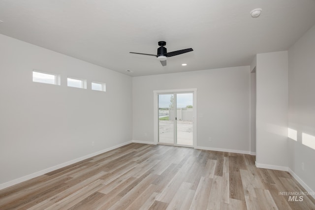 spare room with light hardwood / wood-style floors and ceiling fan