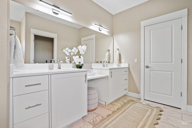 129 E 33 S, Burley, ID 83318 - bathroom featuring marble finish floor, baseboards, a sink, and two vanities