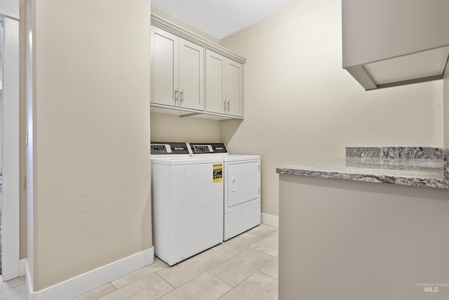 129 E 33 S, Burley, ID 83318 - laundry room featuring washer and clothes dryer, cabinet space, baseboards, and light tile patterned floors