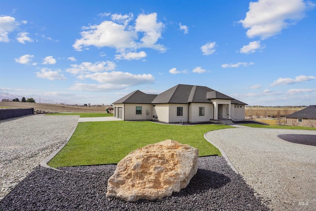 129 E 33 S, Burley, ID 83318 - back of house with stucco siding, driveway, and a yard