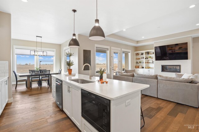 129 E 33 S, Burley, ID 83318 - kitchen with black microwave, a sink, a healthy amount of sunlight, and wood finished floors