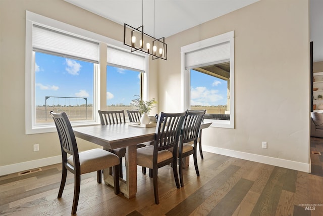 129 E 33 S, Burley, ID 83318 - dining area with an inviting chandelier, visible vents, baseboards, and wood finished floors