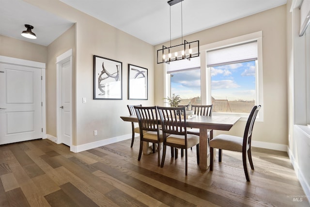 129 E 33 S, Burley, ID 83318 - dining space featuring baseboards, a chandelier, and wood finished floors