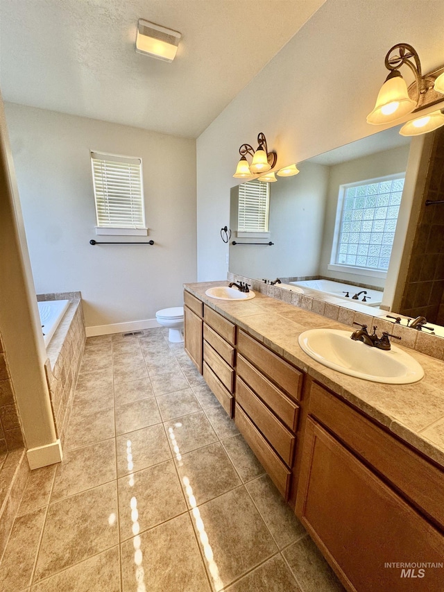 2577 Longbow Dr, Twin Falls, ID 83301 - bathroom with double vanity, a garden tub, and tile patterned floors