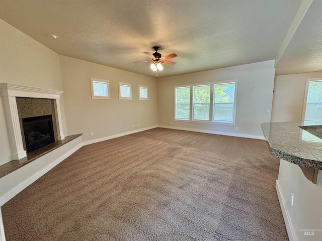 2577 Longbow Dr, Twin Falls, ID 83301 - unfurnished living room with carpet, a ceiling fan, and a premium fireplace