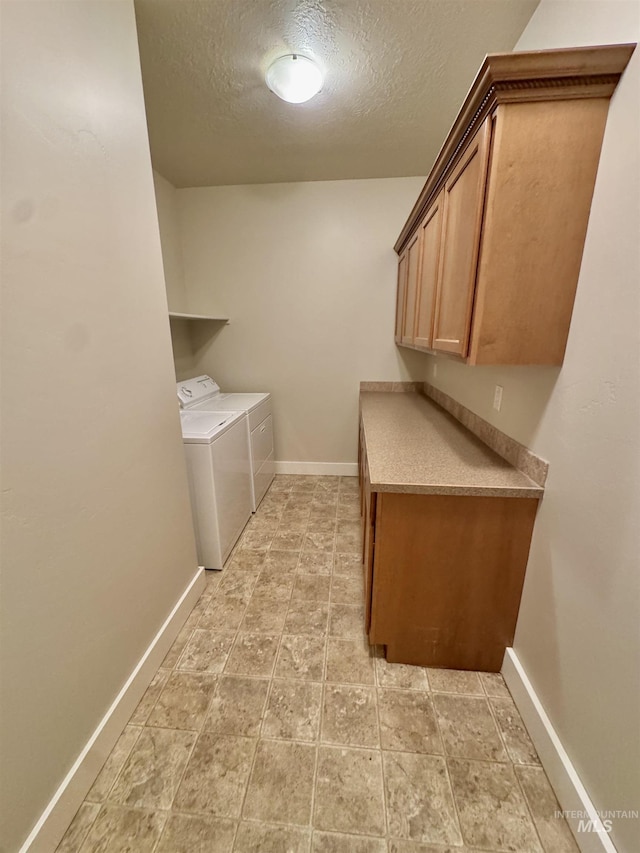 2577 Longbow Dr, Twin Falls, ID 83301 - laundry room with washer and clothes dryer, cabinet space, a textured ceiling, and light stone finish floors