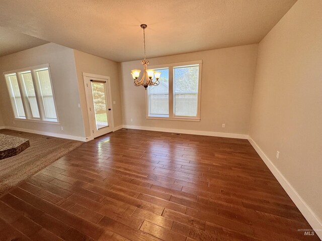 2577 Longbow Dr, Twin Falls, ID 83301 - unfurnished room with dark wood-style flooring and a chandelier