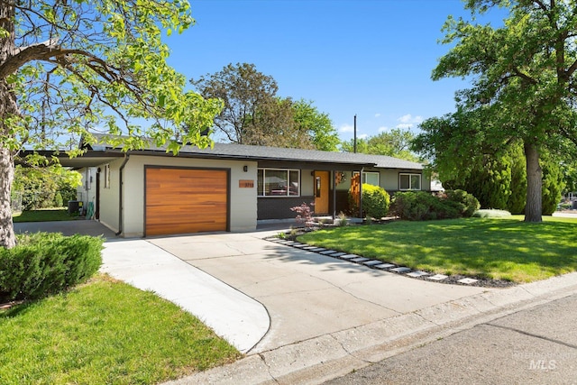 ranch-style house featuring a front lawn, a garage, and driveway