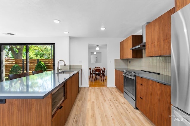 kitchen featuring a sink, modern cabinets, brown cabinets, and stainless steel appliances