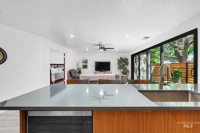 kitchen with a ceiling fan, beverage cooler, visible vents, recessed lighting, and a sink