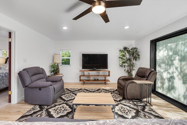 living room featuring light wood finished floors, recessed lighting, baseboards, and ceiling fan