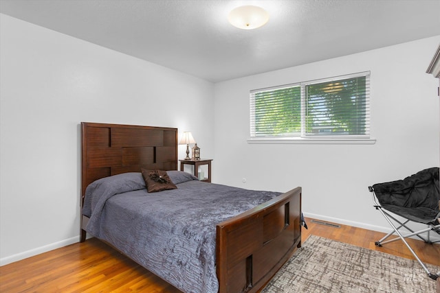 bedroom with visible vents, baseboards, and light wood-style floors