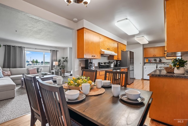 dining space with light hardwood / wood-style flooring and washing machine and clothes dryer