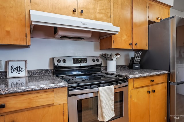 kitchen featuring stainless steel appliances and dark stone counters