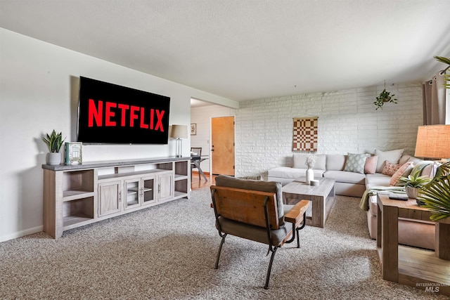 carpeted living room with brick wall