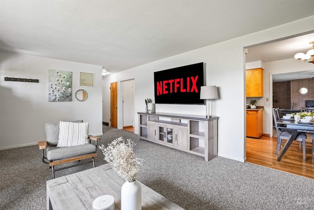 carpeted living room featuring a chandelier