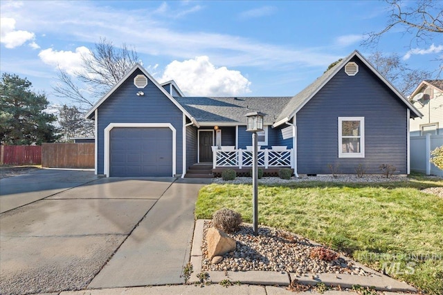 view of front of house featuring a front lawn, covered porch, and a garage