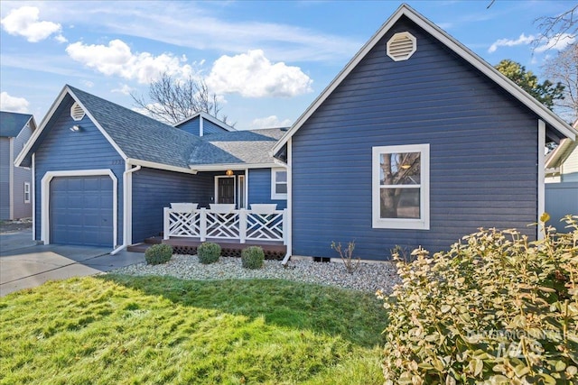 view of front of property with a garage and a front lawn