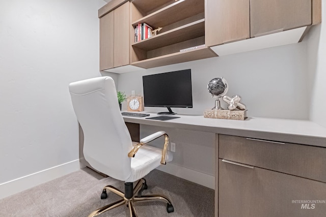 office area featuring carpet flooring and built in desk