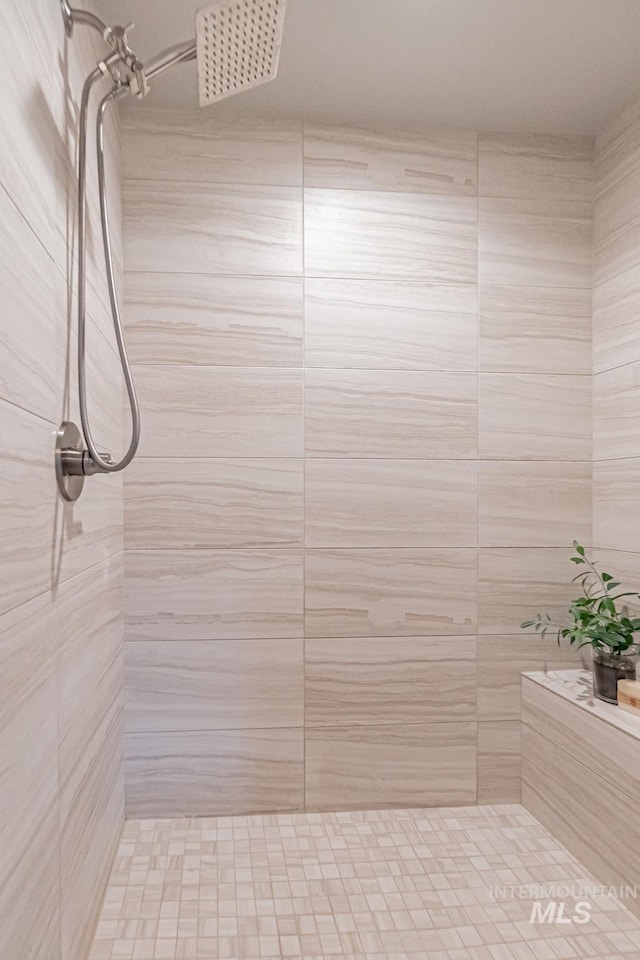 bathroom with tiled shower