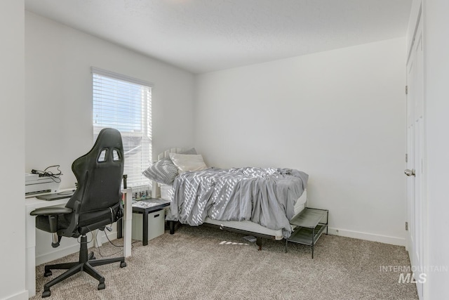 carpeted bedroom featuring baseboards