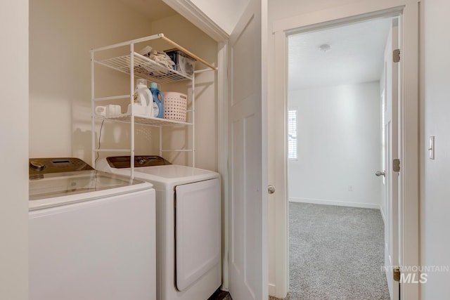 laundry room with laundry area, separate washer and dryer, baseboards, and carpet floors