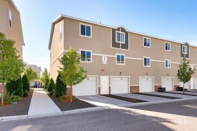 exterior space featuring central air condition unit and an attached garage