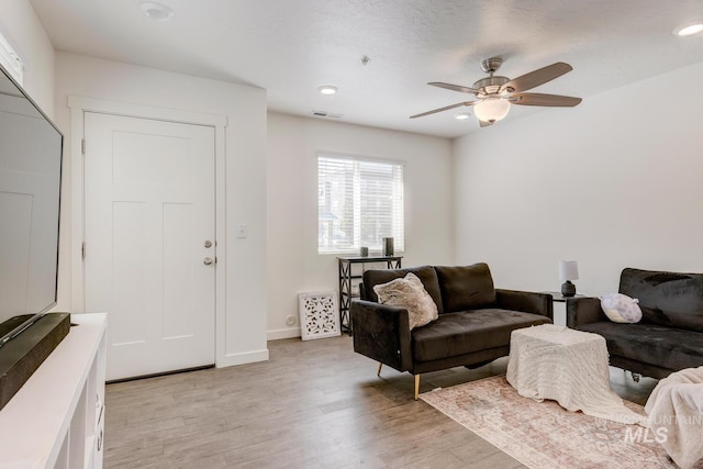 living area with visible vents, ceiling fan, baseboards, recessed lighting, and light wood-style floors