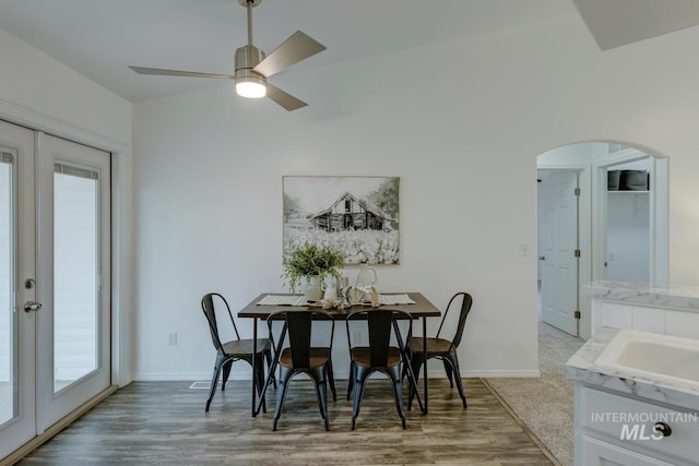 dining space with wood-type flooring, ceiling fan, and a healthy amount of sunlight