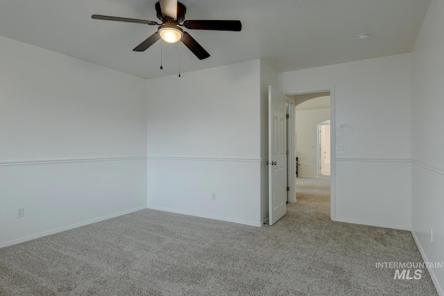 carpeted spare room with ceiling fan