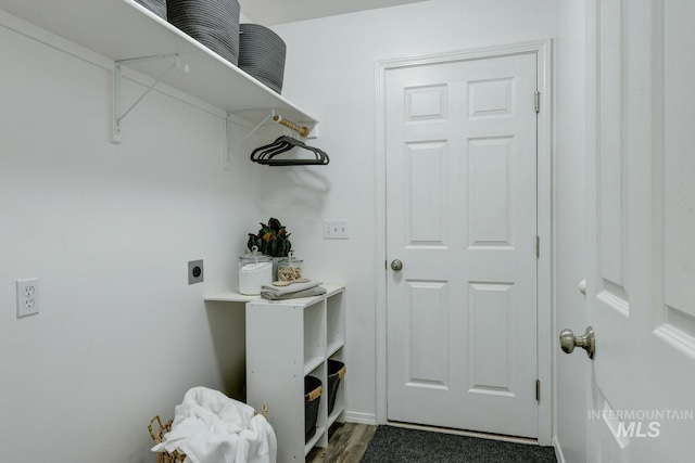 clothes washing area with hookup for an electric dryer and dark wood-type flooring