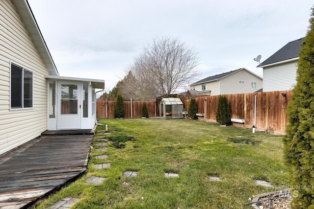 view of yard with a wooden deck and an outbuilding