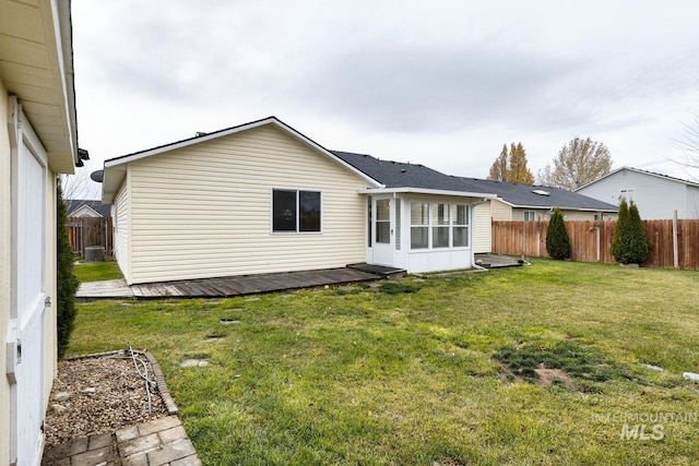 rear view of property featuring a lawn