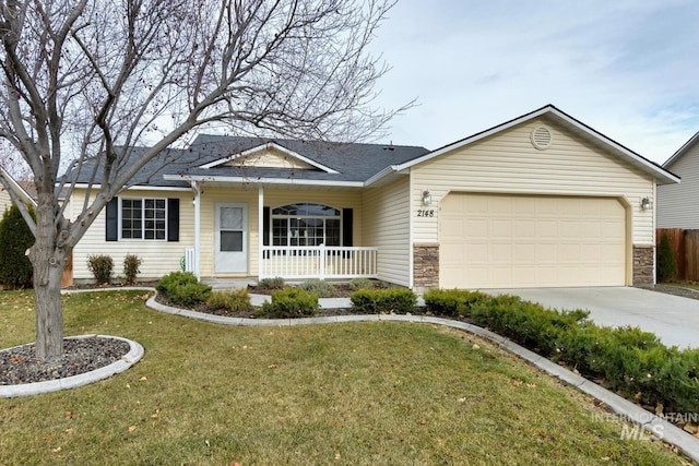 ranch-style home with covered porch, a garage, and a front yard