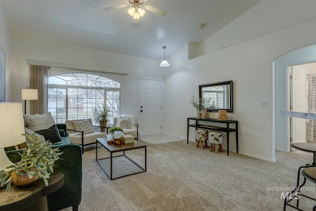 living room featuring ceiling fan, light colored carpet, and lofted ceiling