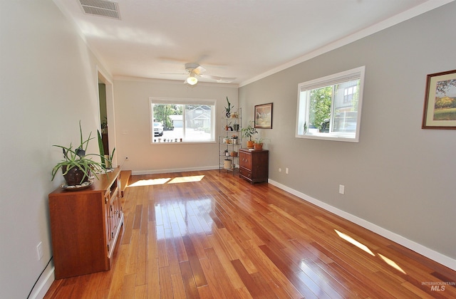 2155 N 24th St, Boise, ID 83702 - spare room with healthy amount of natural light, ornamental molding, light wood-style floors, ceiling fan, and baseboards