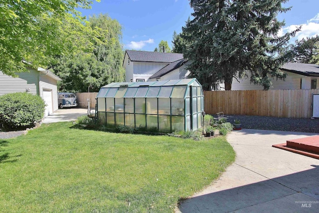 2155 N 24th St, Boise, ID 83702 - view of yard featuring a greenhouse, an outbuilding, and a patio