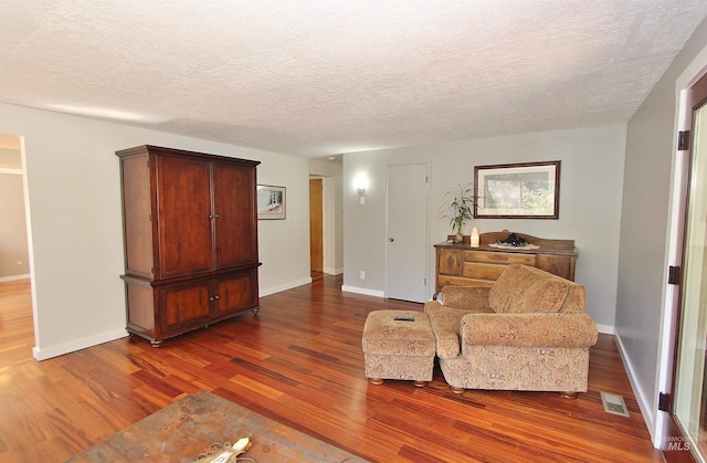 2155 N 24th St, Boise, ID 83702 - sitting room with dark wood-style flooring, baseboards, and a textured ceiling