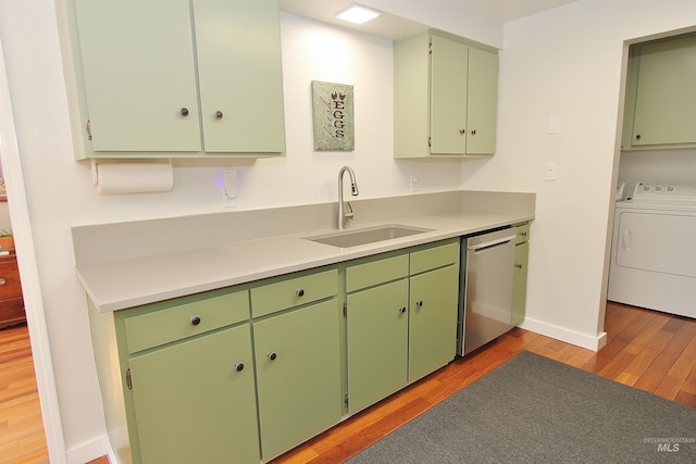 2155 N 24th St, Boise, ID 83702 - kitchen featuring washer / dryer, stainless steel dishwasher, a sink, light wood-type flooring, and baseboards