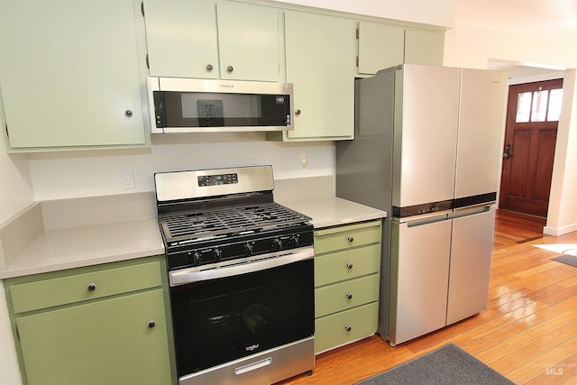 2155 N 24th St, Boise, ID 83702 - kitchen with stainless steel appliances, green cabinetry, light wood-type flooring, and light countertops