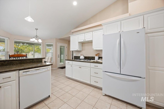 kitchen with lofted ceiling, decorative light fixtures, an inviting chandelier, white cabinets, and white appliances