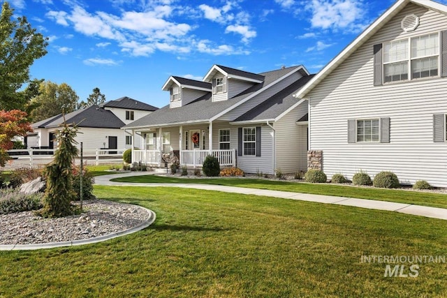 cape cod-style house with covered porch and a front lawn