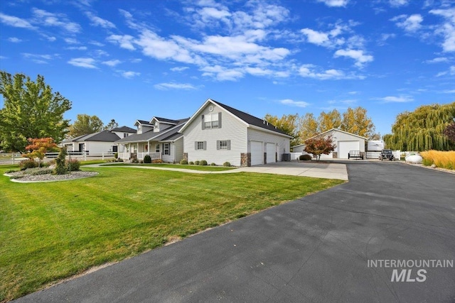 view of front of home with a front yard and a garage