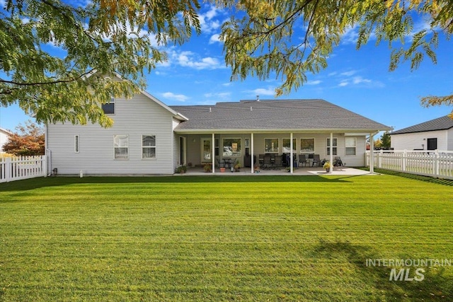 rear view of property with a patio area and a lawn