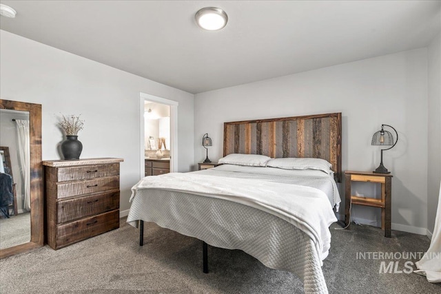 bedroom featuring carpet, connected bathroom, and baseboards