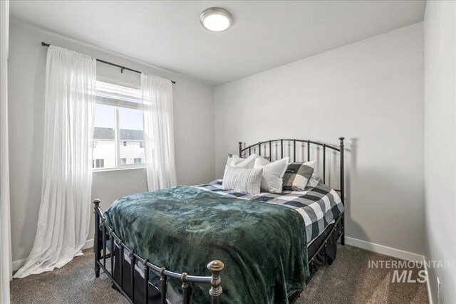 carpeted bedroom featuring baseboards