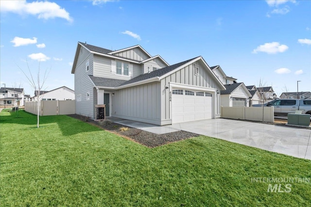 view of front facade with concrete driveway, an attached garage, fence, a front lawn, and board and batten siding