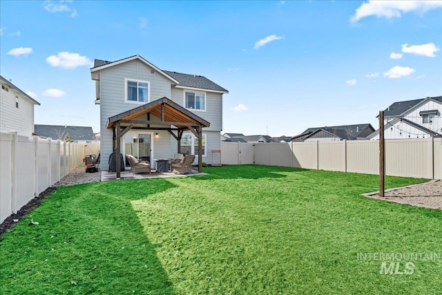 back of property featuring a yard, a patio area, and a fenced backyard