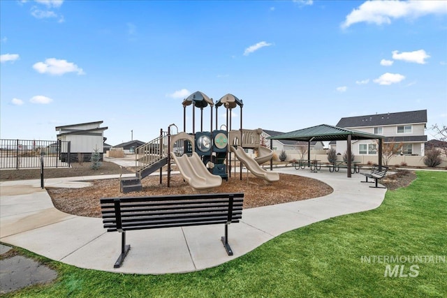 communal playground with a yard, a gazebo, and fence